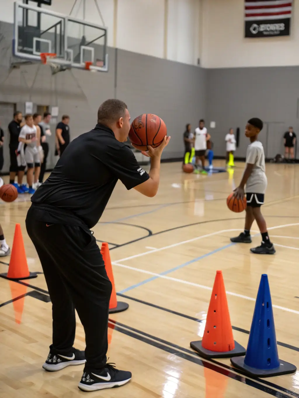 A dynamic image of a basketball coach instructing a group of teenage players on shooting techniques, emphasizing proper form and accuracy, with the ASS TASDON BASKET branding visible on the training jerseys.